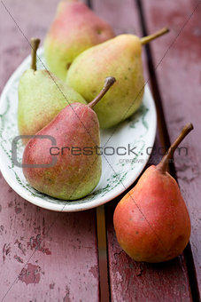 Tasty fragrant pear lying on a white plate