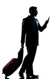business traveler man walking with telephone and  suitcase