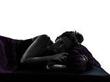  woman in bed sleeping alarm clock silhouette