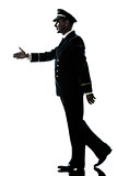 man in airline pilot uniform silhouette walking handshake