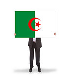 Businessman holding a big card, flag of Algeria