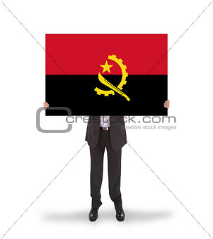 Businessman holding a big card, flag of Angola
