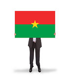 Businessman holding a big card, flag of Burkina Faso