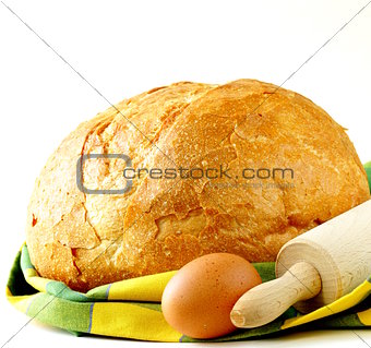 large loaf of homemade bread with a kitchen towel