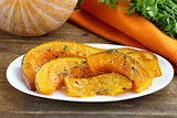 pumpkin baked with herbs and spices on a plate