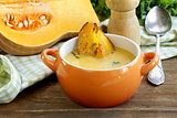pumpkin cream soup with pieces roasted pumpkin and thyme