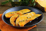 pumpkin baked with herbs and spices in a pan