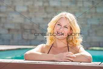 Happy blond girl in pool