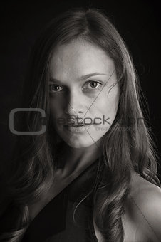 Portrait of a beautiful woman on a black background