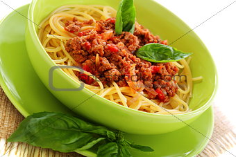 Pasta with tomatoes, meat and basil.