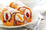 Rolls with cream cheese on a linen napkin.
