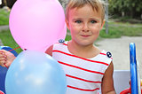 adorable little girl playing with balloons