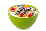 A bowl of cereals with blueberries and raspberries with milk