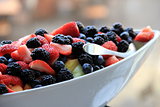 White bowl filled with seasonal fruit