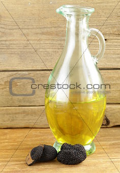 Olive oil flavored with black truffle on a wooden table