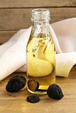 Olive oil flavored with black truffle on a wooden table