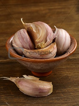 garlic in bowl on a wooden background