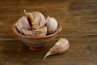 garlic in bowl on a wooden background