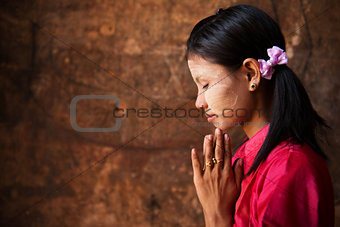 Myanmar girl in a praying pose.