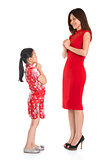 Full length Chinese parent and child greeting to each other