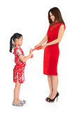 Asian Chinese child receiving monetary gift from parent 