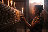 Asian woman praying with candle light