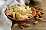 almond paste - marzipan in a bowl with whole nuts