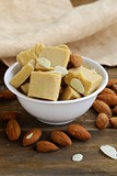 almond paste - marzipan in a bowl with whole nuts