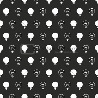 Seamless dark vector pattern or texture with light bulbs on black background.