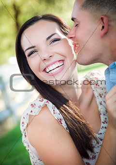 Mixed Race Romantic Couple Whispering in the Park