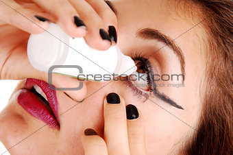 Girl putting eye drops.