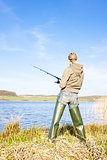 woman fishing at a pond