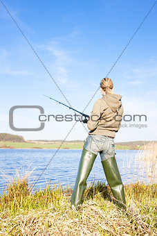 woman fishing at a pond