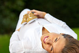 Portrait pregnant woman lying on the grass