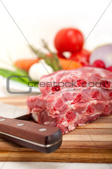 chopping fresh pork ribs and vegetables