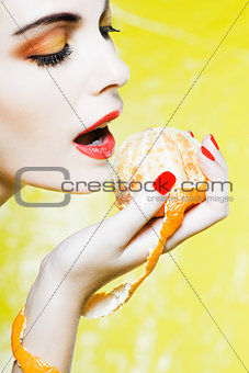 Woman Portrait eating a mandarin orange tangerine fruit