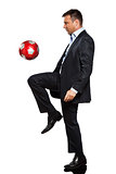 one business man playing juggling soccer ball