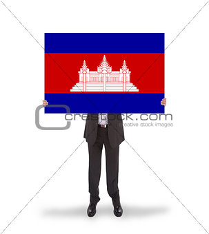 Businessman holding a big card, flag of Cambodia