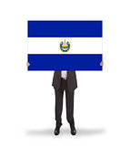 Businessman holding a big card, flag of El Salvador