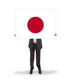 Businessman holding a big card, flag of Japan