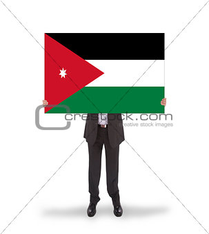 Businessman holding a big card, flag of Jordan