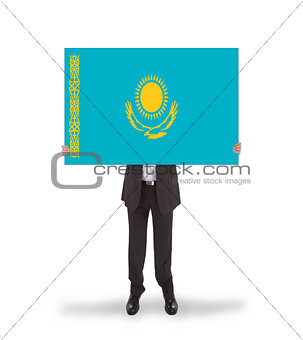 Businessman holding a big card, flag of Kazakhstan
