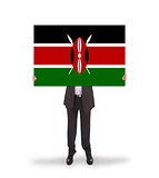 Businessman holding a big card, flag of Kenya