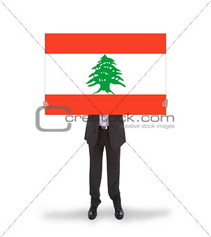 Businessman holding a big card, flag of Lebanon