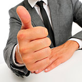 man in suit giving a thumbs up signal