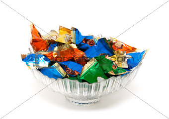 glass vase with candy in colorful wrappers