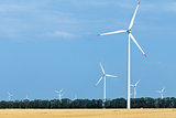 Wind turbine farm above land used for agriculture