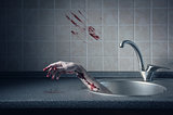 Bloody hand in kitchen sink 