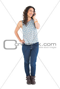 Smiling attractive brunette having phone call