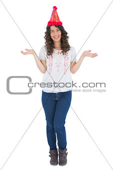 Cheerful casual brunette with party hat posing